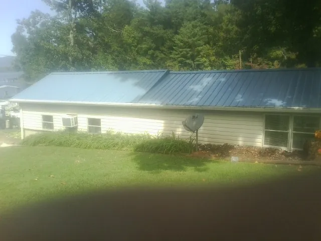 Blue metal roof running the length of a single story home in Lisle