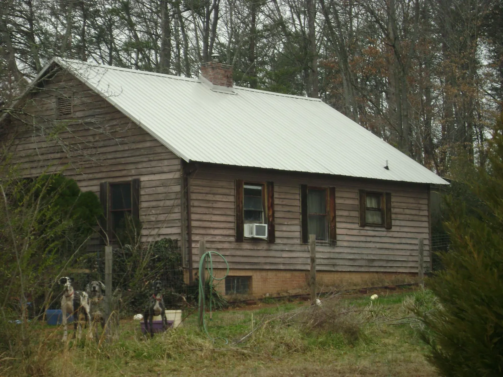 White metal roof on an old wood sided farmhouse, from a Metal Roof Installation job in Lisle